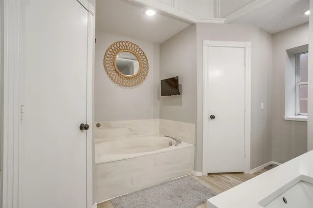 a bathroom with a bathtub and a shower