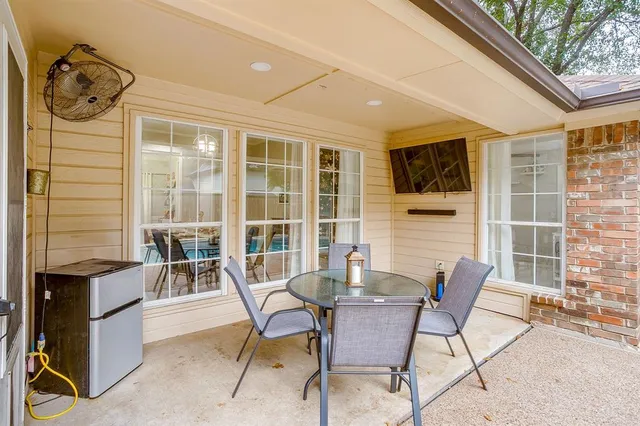 a view of a patio with table and chairs