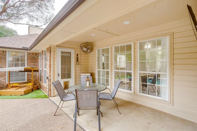 a patio with yard glass top table and chairs