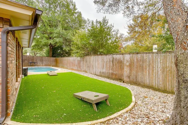 a view of a swimming pool with a backyard and a slide