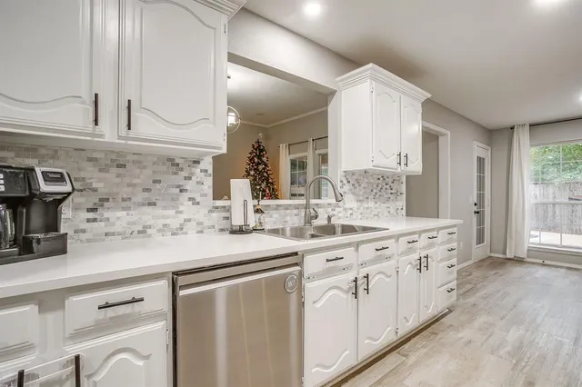 a kitchen with stainless steel appliances granite countertop a sink stove and cabinets