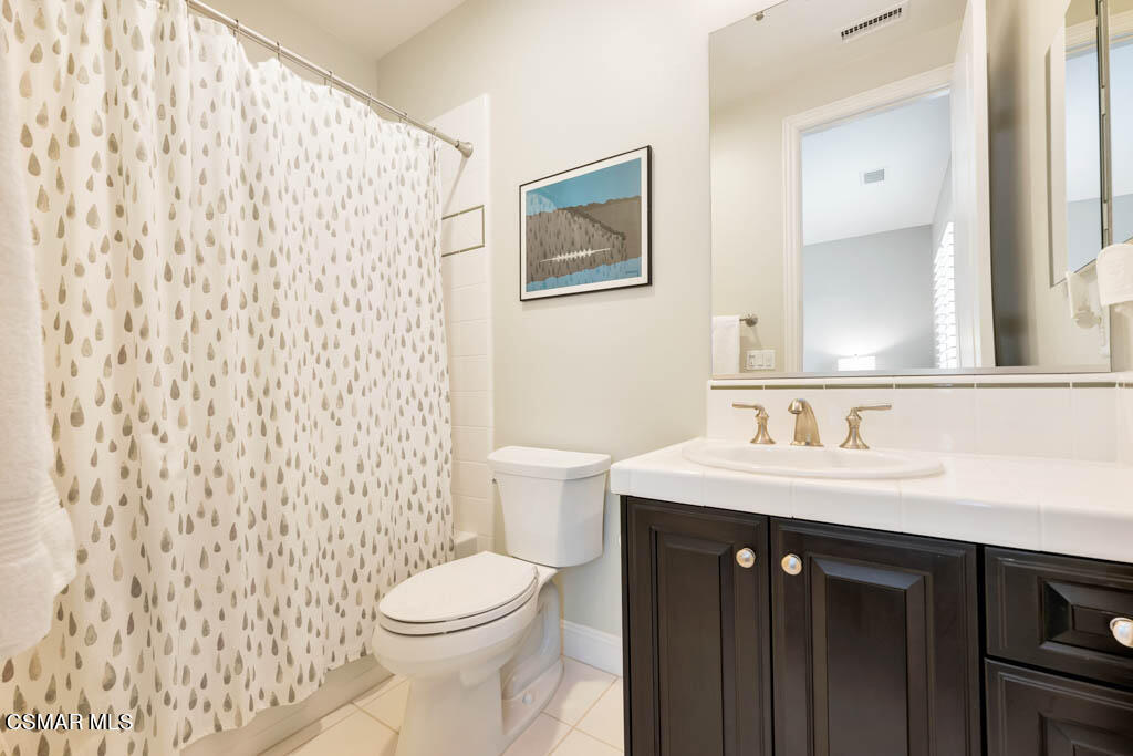 7307 Nicklaus Road Moorpark, CA 93021 - Photo 39 of 96 a bathroom with a sink a toilet and a mirror