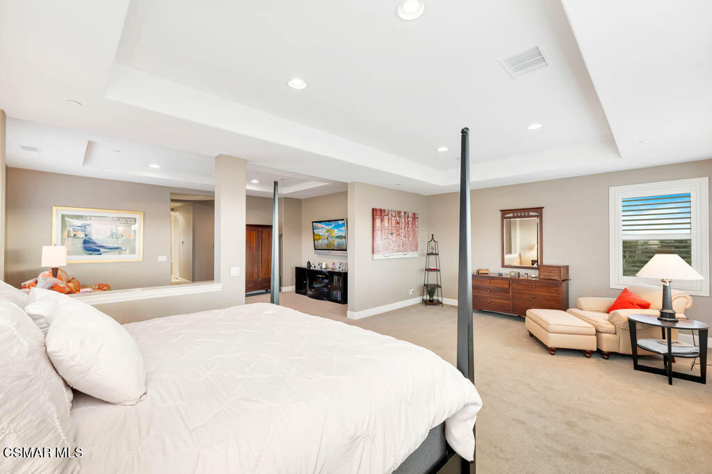 7307 Nicklaus Road Moorpark, CA 93021 - Photo 44 of 96 a spacious bedroom with a bed a couch and large windows
