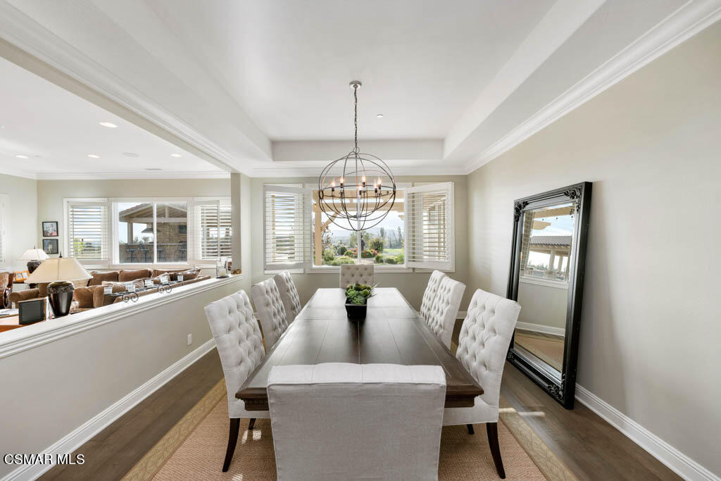 7307 Nicklaus Road Moorpark, CA 93021 - Photo 6 of 96 a dining room with furniture a chandelier and wooden floor