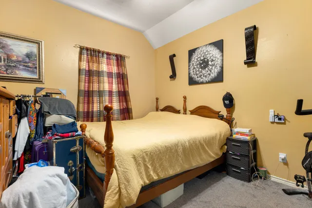 a bedroom with bed and a large window