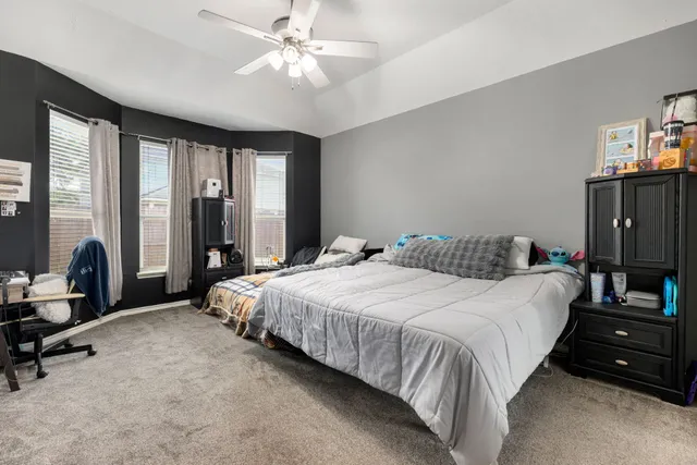a bathroom with a tub a double vanity sink and a mirror