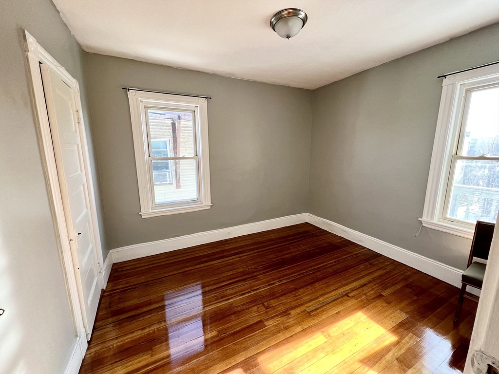 6 Taft Street, Unit 1 Boston, MA 02125 - Photo 6 of 10 a view of a room with wooden floor and window