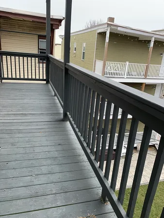 a view of a deck with wooden floor and city view