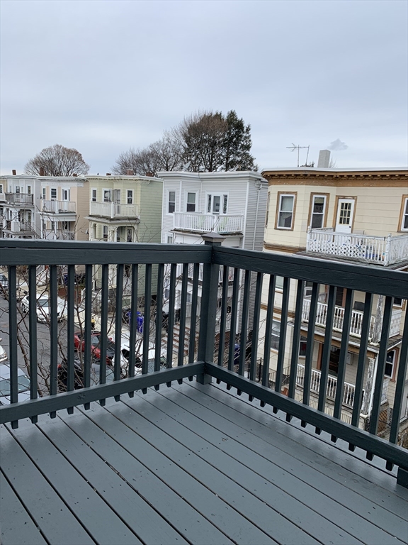 6 Taft Street, Unit 1 Boston, MA 02125 - Photo 10 of 10 a view of a deck with wooden floor and city view