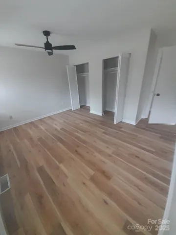 a view of a big room with closet and wooden floor