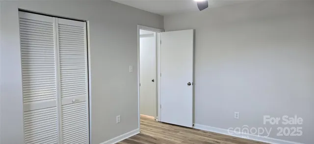 a view of hallway with wooden floor