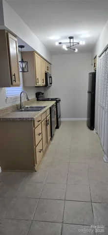 a large kitchen with cabinets and stainless steel appliances