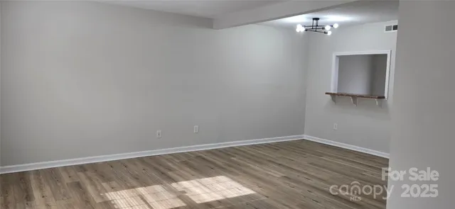 a view of a room with wooden floor and fan
