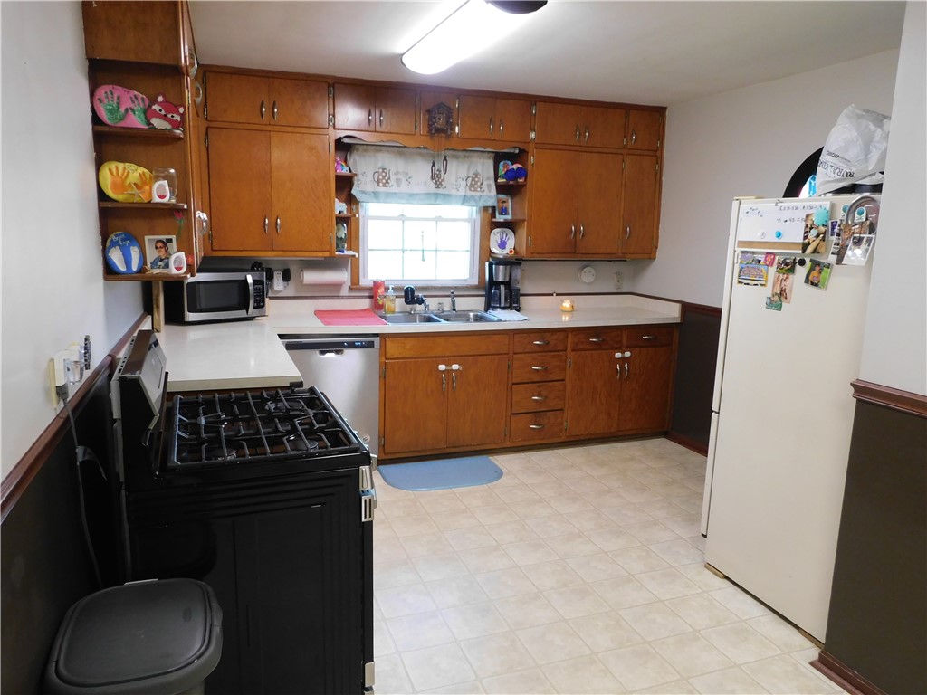 1301 East Main Street Casey, IL 62420 - Photo 4 of 14 a kitchen with granite countertop a stove a sink and a refrigerator