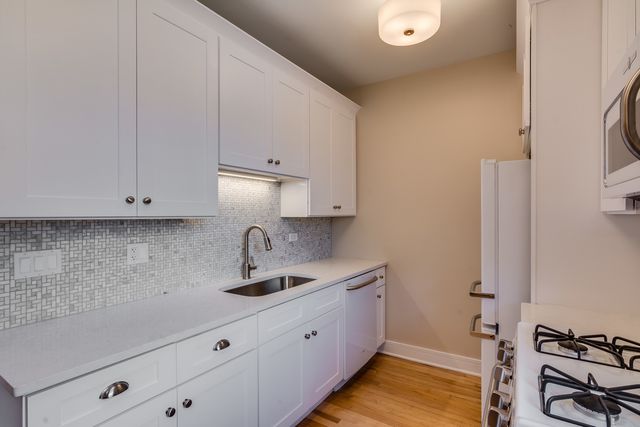 a kitchen with a sink and cabinets