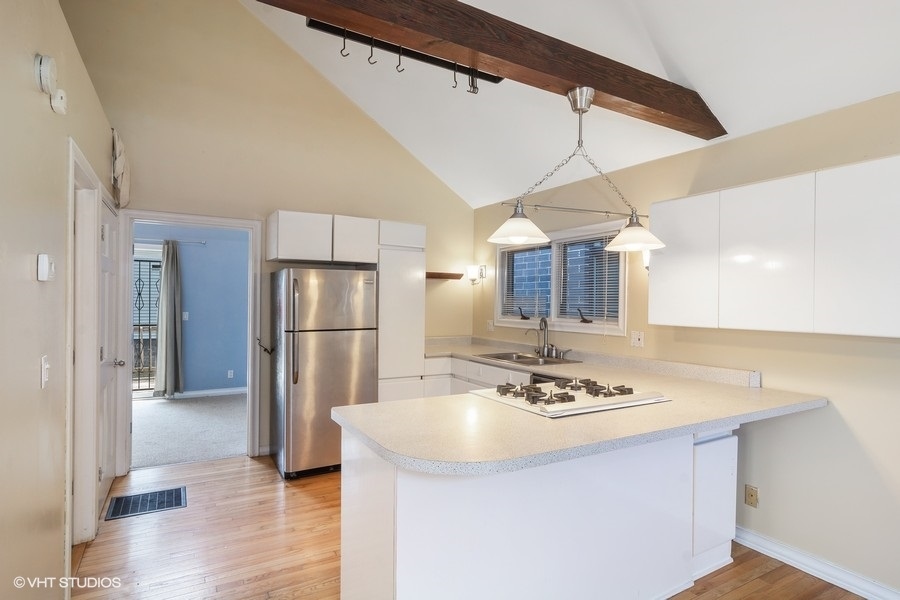 1435 North Mohawk Street, Unit 2 Chicago, IL 60610 - Photo 2 of 6 a kitchen with stainless steel appliances a sink a refrigerator and wooden floor