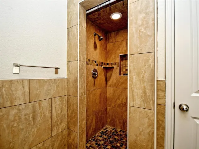 a bathroom with a shower and a sink