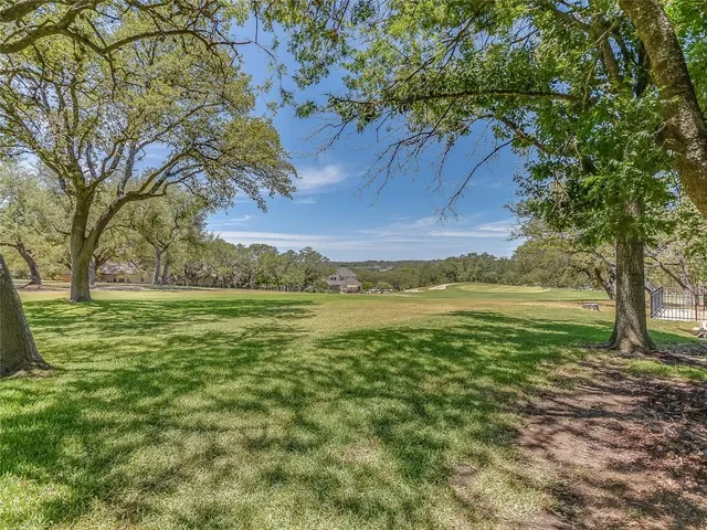 a view of a field with an trees