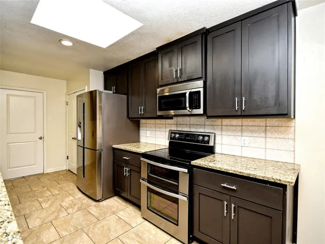 a kitchen with a sink stove and refrigerator