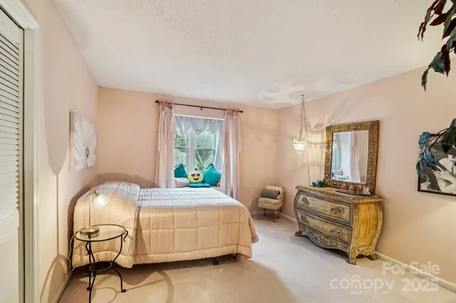 a bedroom with bed and windows