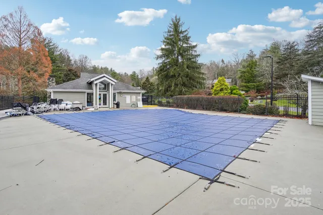 a view of a wooden chairs and table in the backyard