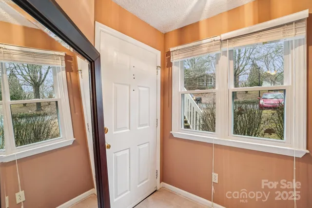 a view of a door and wooden floor