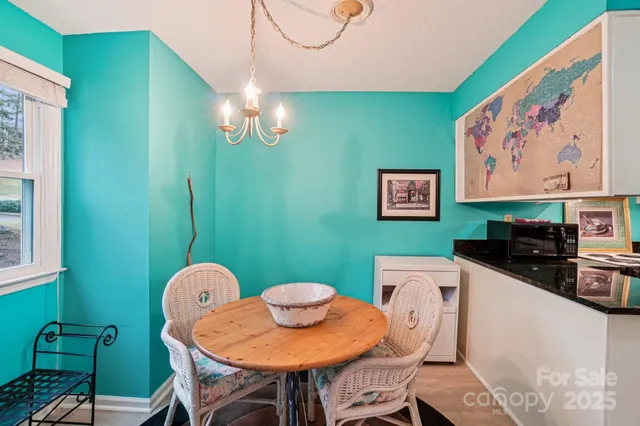 a kitchen with a table chairs and a refrigerator