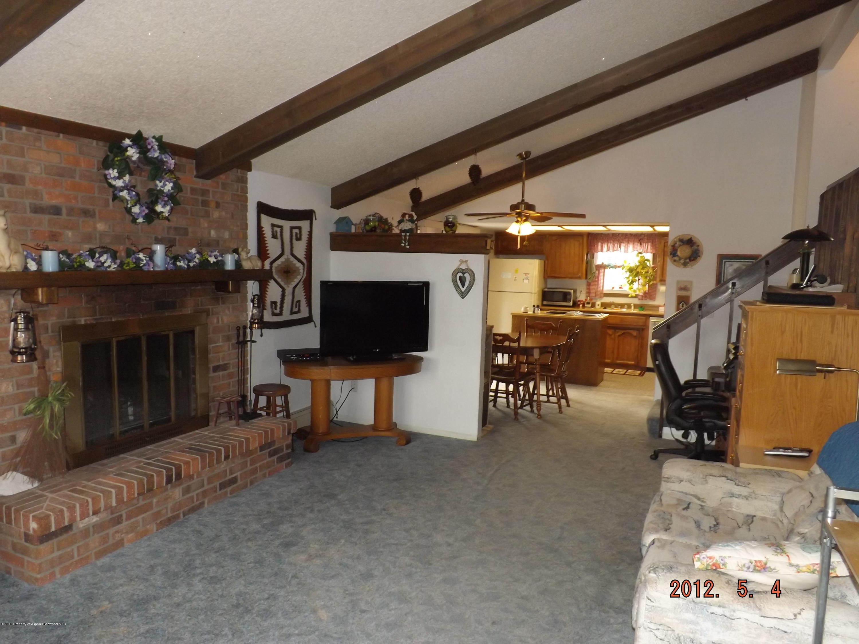 515 East 12th Street Rifle, CO 81650 - Photo 11 of 39 a living room with furniture and a flat screen tv