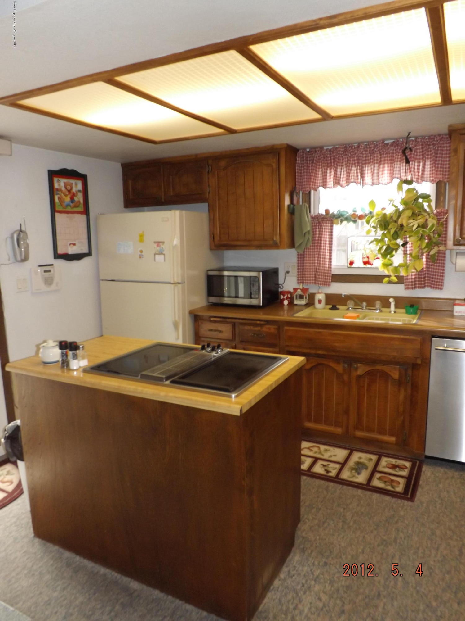 515 East 12th Street Rifle, CO 81650 - Photo 14 of 39 a kitchen with kitchen island a stove a sink and a microwave