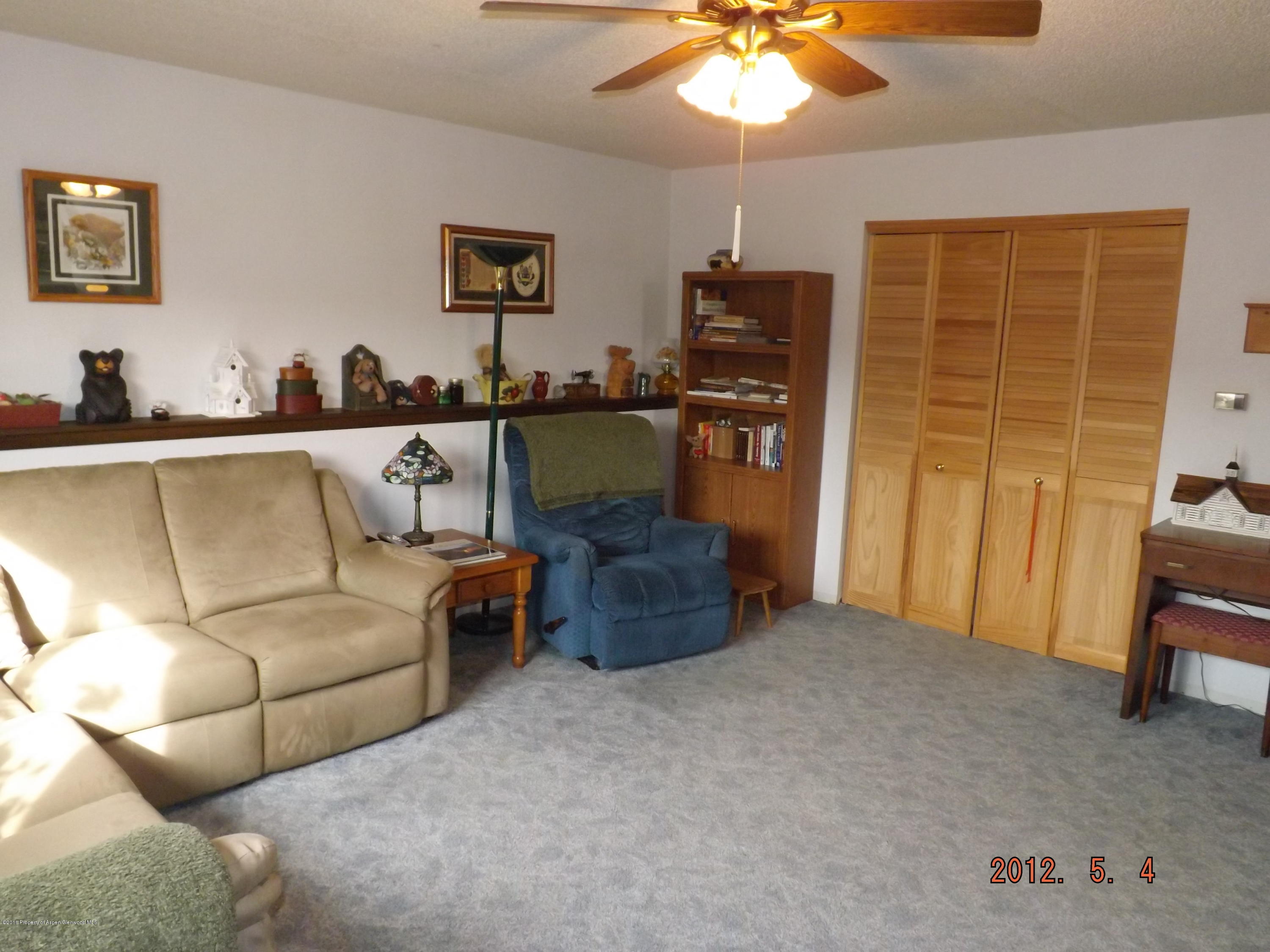 515 East 12th Street Rifle, CO 81650 - Photo 19 of 39 a living room with furniture and a flat screen tv