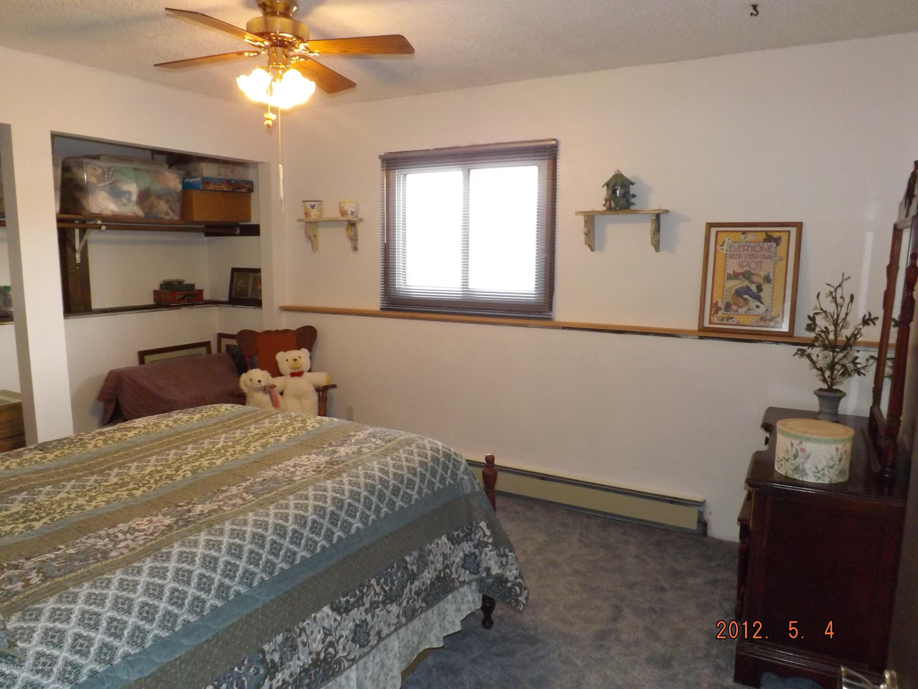515 East 12th Street Rifle, CO 81650 - Photo 22 of 39 a bedroom with a bed and a window