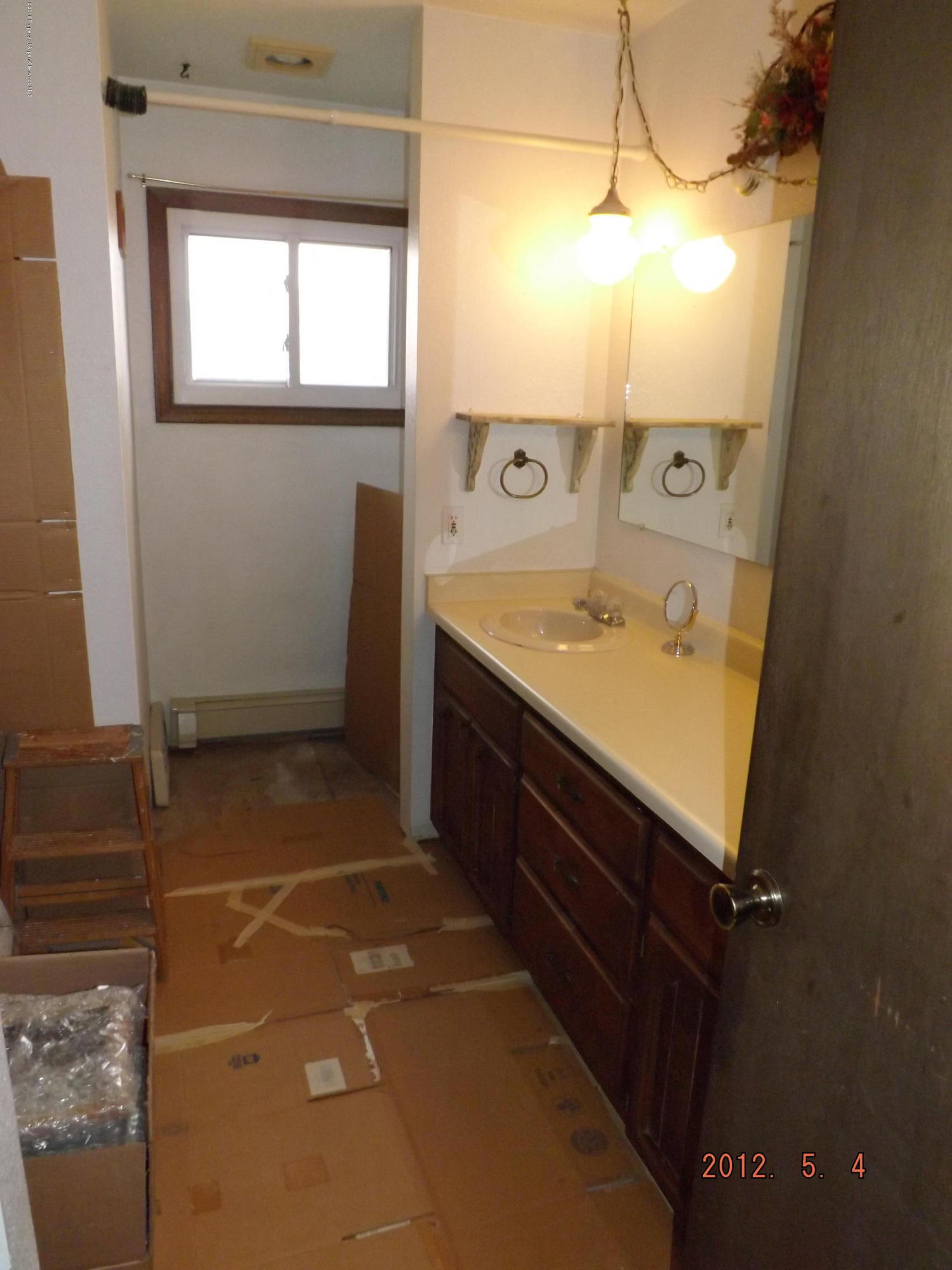 515 East 12th Street Rifle, CO 81650 - Photo 27 of 39 a bathroom with a sink and a mirror