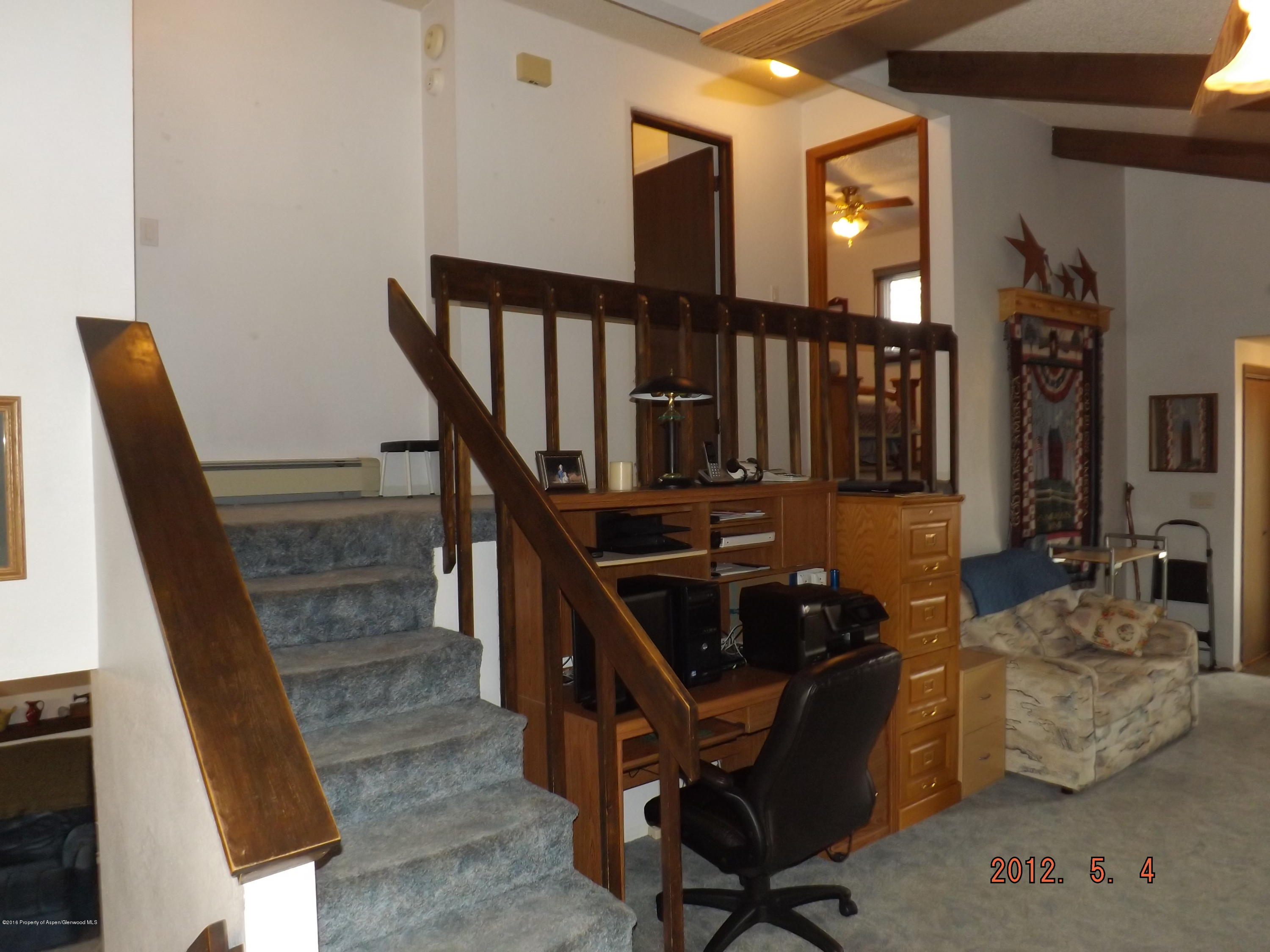 515 East 12th Street Rifle, CO 81650 - Photo 8 of 39 a workspace with wooden floor and furniture