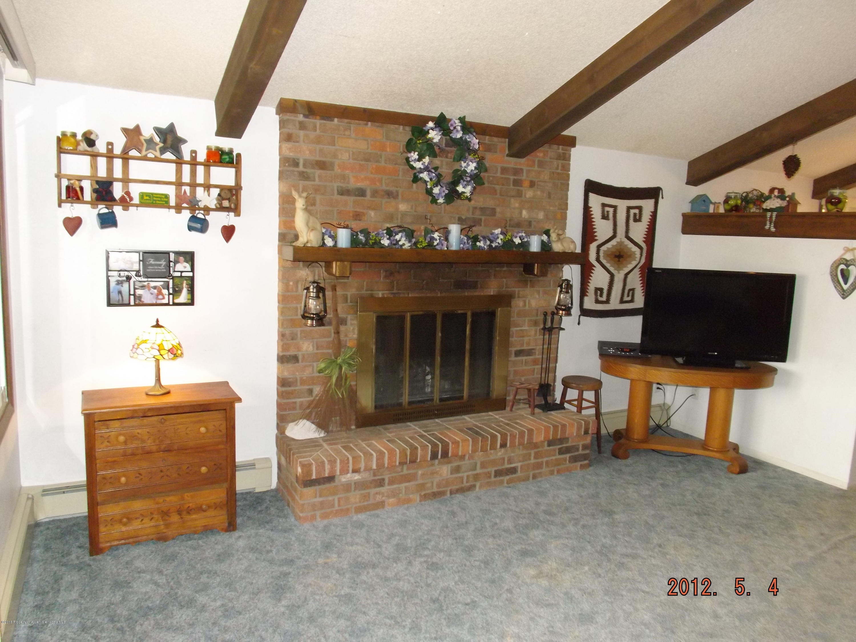 515 East 12th Street Rifle, CO 81650 - Photo 10 of 39 a living room with furniture and a fireplace