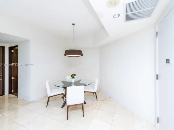 a living room with furniture and a lamp