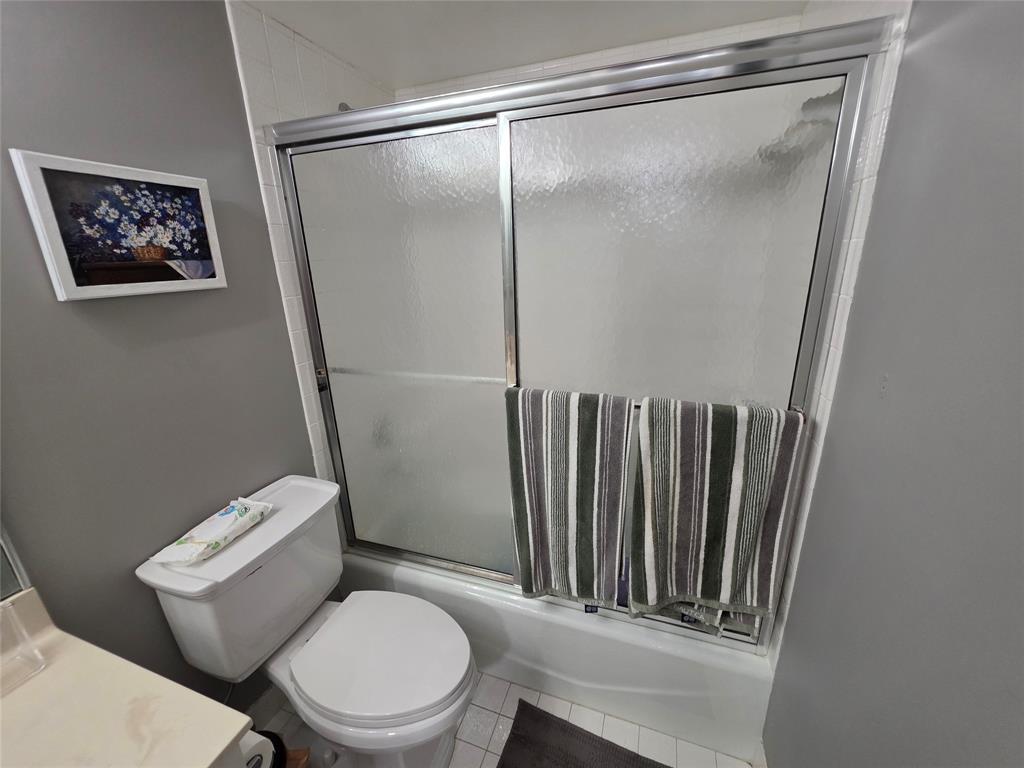 3940 Inverrary Boulevard, Unit 507A Fort Lauderdale, FL 33319 - Photo 13 of 35 a white toilet sitting next to a bathroom sink