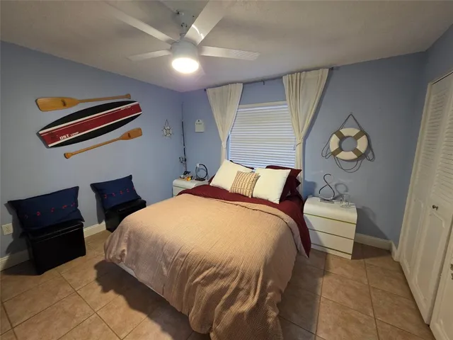 a bedroom with furniture and a flat screen tv
