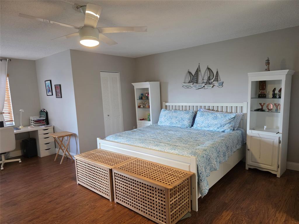 3940 Inverrary Boulevard, Unit 507A Fort Lauderdale, FL 33319 - Photo 17 of 35 a bedroom with a bed and a chandelier