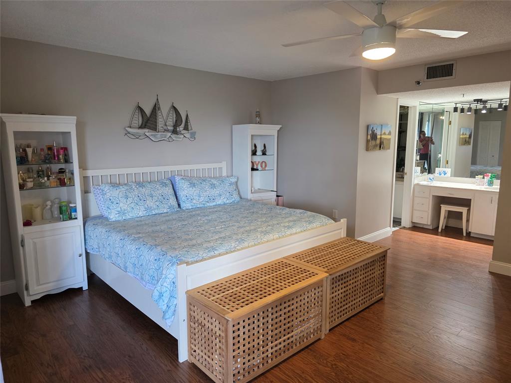 3940 Inverrary Boulevard, Unit 507A Fort Lauderdale, FL 33319 - Photo 19 of 35 a bedroom with a large bed and a chandelier