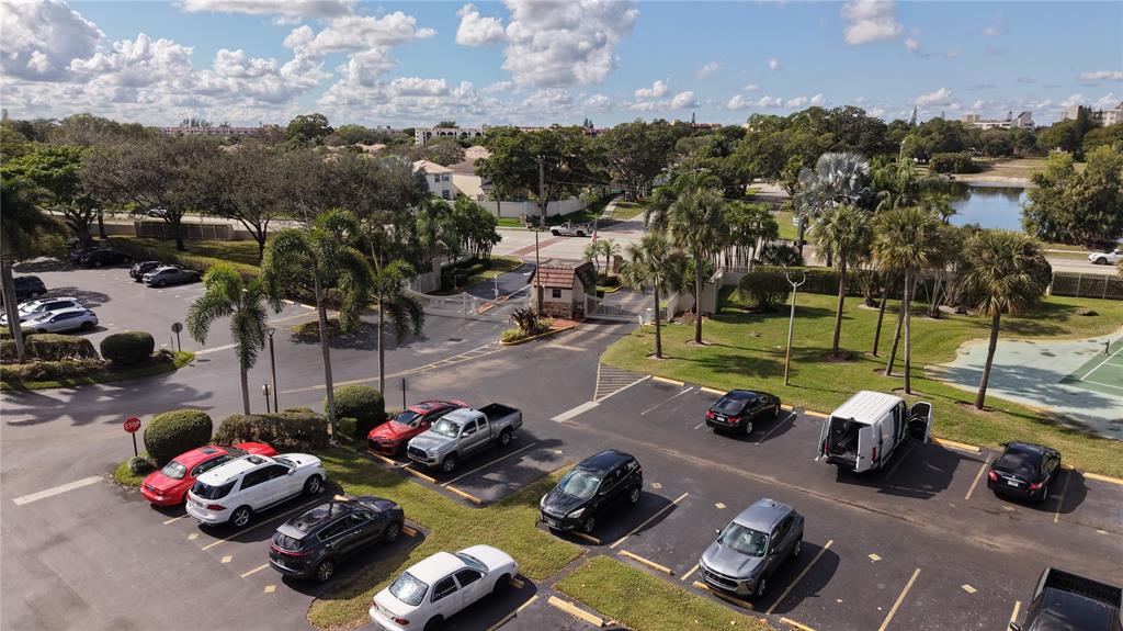 3940 Inverrary Boulevard, Unit 507A Fort Lauderdale, FL 33319 - Photo 31 of 35 a view of a backyard with table and chairs and a floor to ceiling window