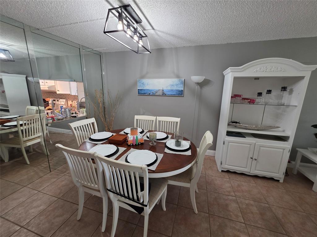 3940 Inverrary Boulevard, Unit 507A Fort Lauderdale, FL 33319 - Photo 10 of 35 a dining room with furniture and window
