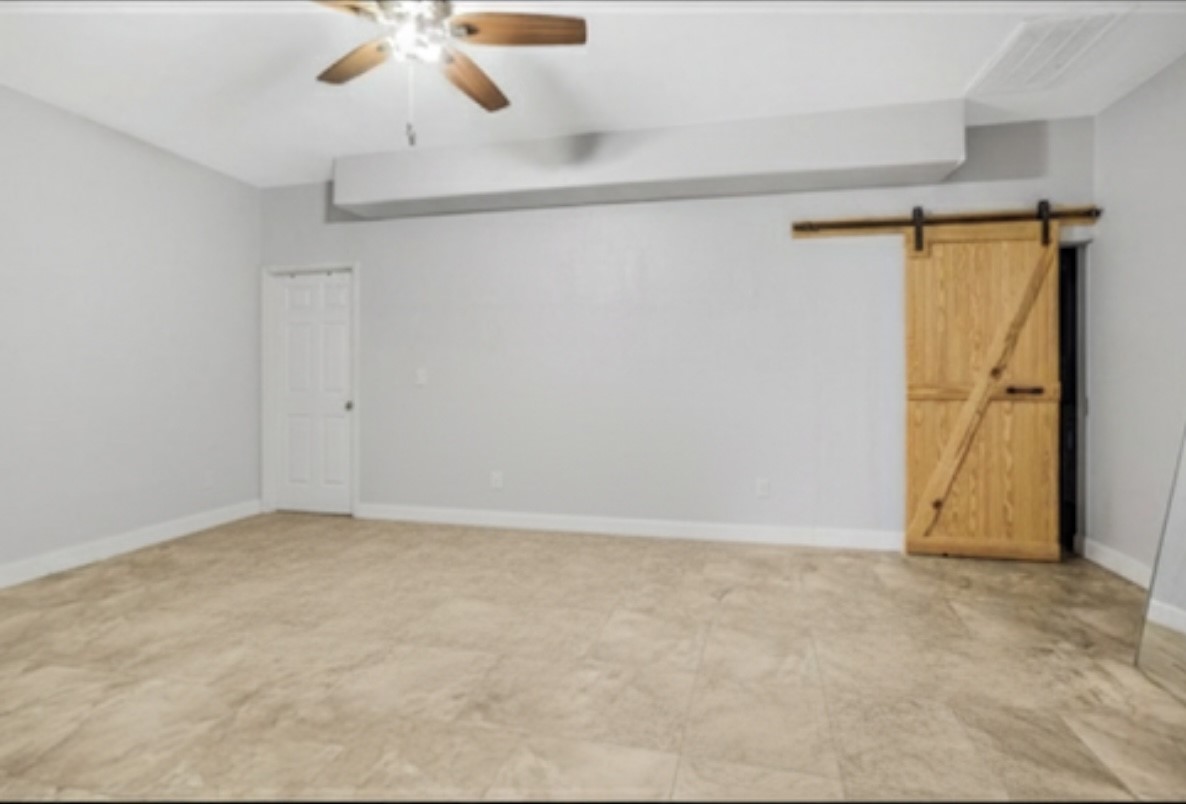 20547 Crosby Eastgate Road Crosby, TX 77532 - Photo 39 of 44 Primary bedroom in the casita. Behind the barn door is the utility room. The enormous closet is behind the white door.