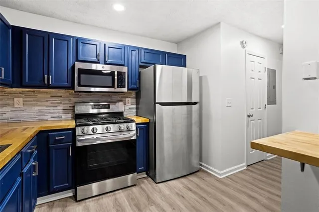 a kitchen with wooden cabinets and stainless steel appliances