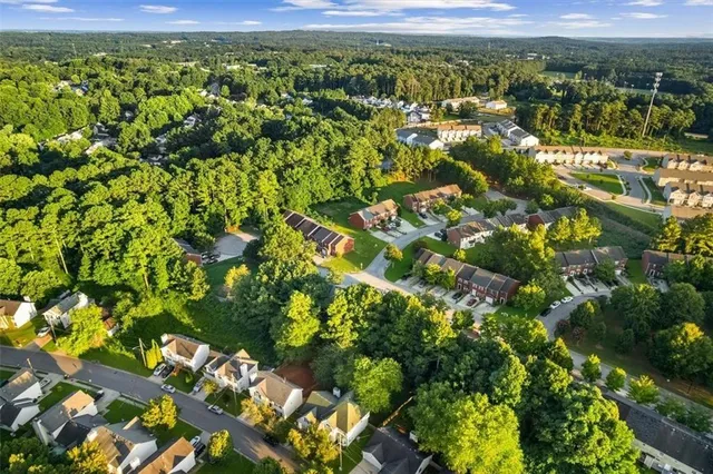 a view of a city with lush green forest