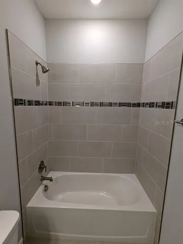 a bathroom with a shower and a bathtub