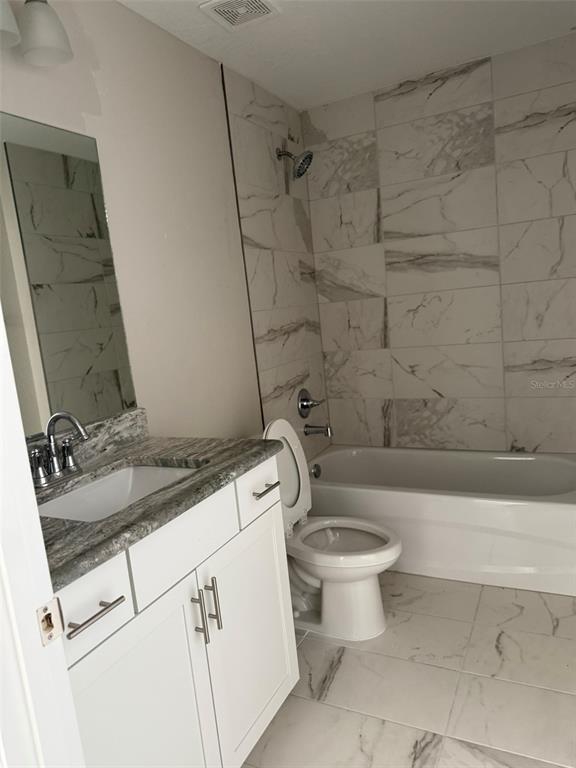 9545 North Travis Drive, Unit B Citrus Springs, FL 34434 - Photo 3 of 11 a bathroom with a sink a toilet and shower