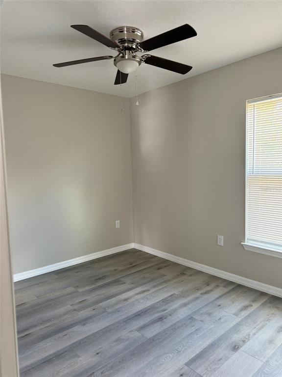 9545 North Travis Drive, Unit B Citrus Springs, FL 34434 - Photo 4 of 11 a view of an empty room with wooden floor and a window