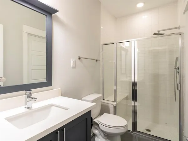a bathroom with a sink toilet and shower