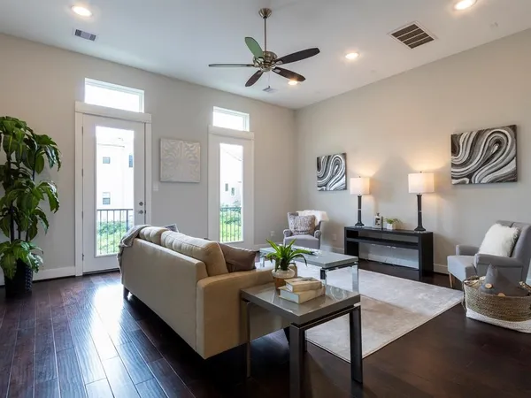 a living room with furniture and a wooden floor