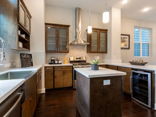a kitchen with stainless steel appliances granite countertop a sink stove and refrigerator
